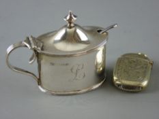 AN OVAL SILVER MUSTARD POT with Bristol blue liner and plated mustard spoon and a bright cut