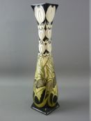 A TALL MOORCROFT POTTERY VASE, unknown design by Paul Hilditch, decorated on a black ground,