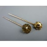 TWO YELLOW METAL STICK PINS, one with centre pearl and the other with a centre garnet