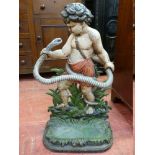 A VICTORIAN CAST IRON STICKSTAND modelled as a young Hercules wrestling a serpent, with pierced