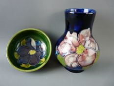 A MOORCROFT 'CLEMATIS' 10.5 cms HIGH VASE, decorated on a cobalt ground, impressed Moorcroft to