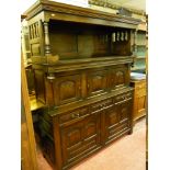 AN ANTIQUE REPRODUCTION OAK WELSH TRIDARN having a pillared top hood and a centre section with three