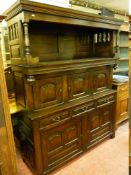 AN ANTIQUE REPRODUCTION OAK WELSH TRIDARN having a pillared top hood and a centre section with three