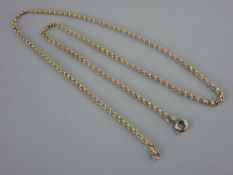 A BELIEVED NINE CARAT GOLD MUFF CHAIN, 6.2 grms