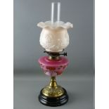 A VICTORIAN OIL LAMP, brass column with milk glass shade and milk glass floral decorated reservoir