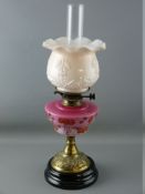 A VICTORIAN OIL LAMP, brass column with milk glass shade and milk glass floral decorated reservoir