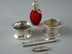 TWO BRIGHT CUT SILVER NAPKIN RINGS, 0.8 ozs, a silver handbag pencil and a silver topped cranberry