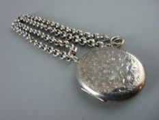A SILVER OVAL PHOTO LOCKET with bright cut leaf decoration to one side with a sterling muff type