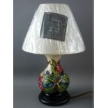 A MOORCROFT 'SIMEON' TABLE LAMP & SHADE, designed by Phillip Gibson, 35 cms high overall