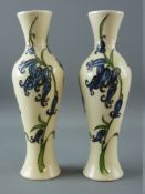 A PAIR OF MOORCROFT 'BLUEBELL HARMONY' CREAM GROUND VASES having narrow necks with narrowing