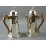 A PAIR OF PLAIN SILVER CHOCOLATE POTS of slightly domed octagonal form and with a domed and