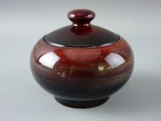 A MOORCROFT POTTERY POT & COVER of circular plain form, decorated in mottled blue to red tones,