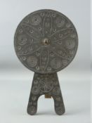A WELSH SLATE FOLK ART piece in the form of a carved circular disc on an easel type stand, the stand