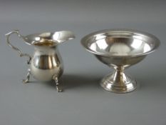 A PLAIN NARROW NECKED SILVER CREAM JUG on three pad supports with scrolled handle, 2.3 troy ozs,