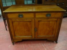 A COMPACT MAHOGANY SIDEBOARD having a railback with two drawers and two cupboards and on corner