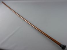 A HARDWOOD MEASUREMENT WALKING CANE with ebony top, marked out to 48 ins, the reverse marked out and