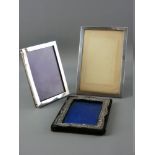 TWO PLAIN SILVER EASEL PICTURE FRAMES and another (distressed)