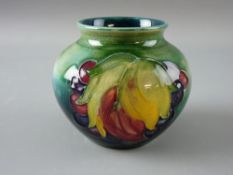 A MOORCROFT 'LEAF & BERRY' SQUAT VASE decorated on a tonal green ground, impressed Moorcroft to