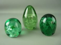 THREE VICTORIAN GREEN GLASS DUMP PAPERWEIGHTS, all having multiple floral inclusions, 12.5 cms