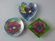 THREE MOORCROFT 'CLEMATIS' & 'ANEMONE' VARIOUS SHAPED PIN DISHES, decorated on green or tonal blue