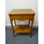 A NEAT LIGHT OAK OBLONG TOPPED CUTLERY CANTEEN having a shaped front apron and base shelf