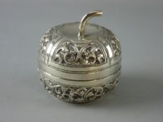 A WHITE METAL PUMPKIN SHAPED LIDDED CONTAINER with raised trailing leaf decoration, stamped ??90,