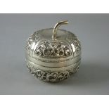 A WHITE METAL PUMPKIN SHAPED LIDDED CONTAINER with raised trailing leaf decoration, stamped ??90,