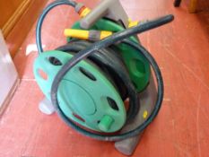 Garden hose reel with hose lock attachments