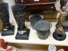 Pair of metallic vases on square plinths, a pair of pewter planter pots, an angel ornament and a