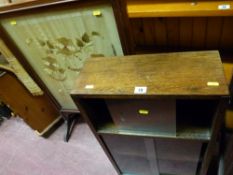 Framed silk firescreen, small glazed door bookcase and a narrow modern pine chest of drawers