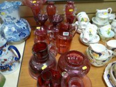 Approximately twelve pieces of cranberry glass jugs and vases etc