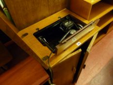 Electric Singer sewing machine in an oak cabinet