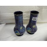 Pair of Royal Doulton chimney type vases, blue ground with raised decoration and bulbous bases