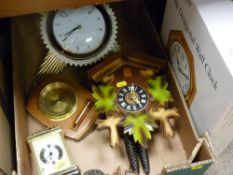 Modern twin weight cuckoo clock, a starburst wall clock and two others and a boxed wall clock