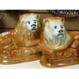 Pair of large oval based early 20th Century Staffs pottery reclining lions