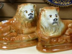 Pair of large oval based early 20th Century Staffs pottery reclining lions
