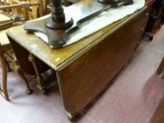 Excellent scrolled edged gate leg table with a set of six (five plus one) splatback chairs plus