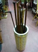 Collection of hardwood and other walking canes in a modern pottery stickstand