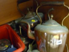 Four copper kettles, a brass kettle and a skillet