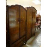 A suite of vintage polished bedroom furniture including two double wardrobes, dressing table, bed