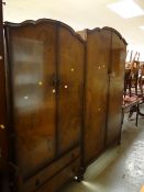 A suite of vintage polished bedroom furniture including two double wardrobes, dressing table, bed