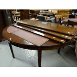 An antique extending D-end dining table