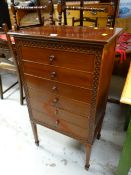 An antique mahogany six-drawer music cabinet