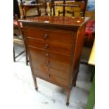 An antique mahogany six-drawer music cabinet