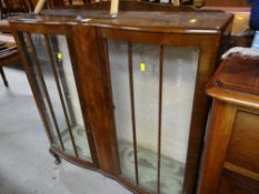 A vintage polished serpentine front glazed china cabinet