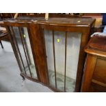 A vintage polished serpentine front glazed china cabinet