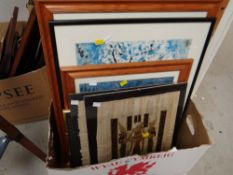 A box containing contemporary prints, clip framed Egyptian papyrus painting etc