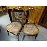 A pair of balloon back chairs with cane seats & a vintage tapestry fire screen
