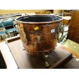 An antique copper log bin with three brass claw feet & brass lion head ring handles together with