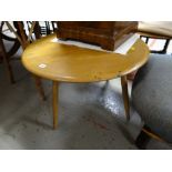 A lightwood Ercol circular coffee table